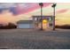 A home with a two car garage and desert landscaping at sunset at 1819 W Joy Ranch Rd, Phoenix, AZ 85086