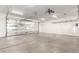 Spacious garage with white walls, overhead racks, and large insulated garage door at 1819 W Joy Ranch Rd, Phoenix, AZ 85086