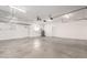 Spacious garage with white walls, high ceilings, overhead storage racks, and multiple doors at 1819 W Joy Ranch Rd, Phoenix, AZ 85086