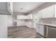 Spacious kitchen featuring white cabinets, quartz countertops, and stainless-steel appliances at 1819 W Joy Ranch Rd, Phoenix, AZ 85086
