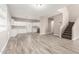 A spacious area with new flooring, stairs, and a kitchen view at 1819 W Joy Ranch Rd, Phoenix, AZ 85086