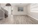 A spacious living room with new gray flooring and fresh paint at 1819 W Joy Ranch Rd, Phoenix, AZ 85086