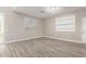 Bright living room featuring wood floors, a large window, and white trim at 1819 W Joy Ranch Rd, Phoenix, AZ 85086