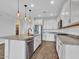 Bright kitchen featuring white cabinets, stainless steel appliances, granite counters, and stylish pendant lighting at 18445 W Pasadena Ave, Litchfield Park, AZ 85340