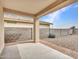 Covered patio with concrete flooring and desert landscaping, ideal for outdoor living at 18445 W Pasadena Ave, Litchfield Park, AZ 85340