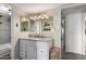 Bathroom featuring a vanity with granite counters, decorative mirrors, and modern lighting fixtures at 1920 W Lindner W Ave # 277, Mesa, AZ 85202
