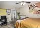 Cozy bedroom with a ceiling fan, desk, neutral tones, and a leafy plant at 1920 W Lindner W Ave # 277, Mesa, AZ 85202