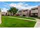 Well-maintained condominium complex with lush green lawns and mature trees at 1920 W Lindner W Ave # 277, Mesa, AZ 85202