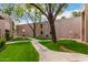 Exterior shot of condominiums featuring grassy common area and walking paths at 1920 W Lindner W Ave # 277, Mesa, AZ 85202