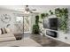 Cozy living room featuring a ceiling fan, diamond-paned window, and sleek hardwood floors at 1920 W Lindner W Ave # 277, Mesa, AZ 85202