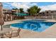 Community pool area with lounging chairs, shaded structures, and clear blue water at 1920 W Lindner W Ave # 277, Mesa, AZ 85202