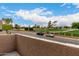 Golf course view from balcony featuring lush green grass and mature trees in the distance at 1920 W Lindner W Ave # 277, Mesa, AZ 85202