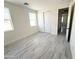 Bright bedroom features gray flooring, white trim, and an opening to another room at 22536 W Huntington Dr, Buckeye, AZ 85326