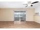 Bright living room featuring new laminate flooring, a ceiling fan, and access to the outdoor area through sliding doors at 2540 E Riviera Dr, Tempe, AZ 85282