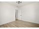 A minimalist bedroom featuring light colored wood flooring and modern lighting at 2601 E Willetta St, Phoenix, AZ 85008