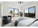 Bright bedroom featuring large windows, a decorative rug, modern chair, and neutral color palette at 2601 E Willetta St, Phoenix, AZ 85008