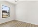 Bright bedroom with light wood floors, white walls, and a large window allowing for natural light at 2601 E Willetta St, Phoenix, AZ 85008
