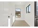 A hallway with white walls and trim, light wood floors and modern black door hardware at 2601 E Willetta St, Phoenix, AZ 85008