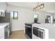 Kitchen with stainless steel appliances, white countertops, and a stylish gold and black pendant light at 2601 E Willetta St, Phoenix, AZ 85008
