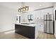 Sleek kitchen with stainless-steel refrigerator, modern lighting, and ample counter space for meal preparation at 2601 E Willetta St, Phoenix, AZ 85008