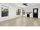 Bright living room with large windows, a modern ceiling fan, and plenty of space for relaxation at 2601 E Willetta St, Phoenix, AZ 85008