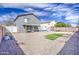 Backyard featuring a gravel landscape, covered patio and gray two story house at 2607 W Ironstone Ave, Apache Junction, AZ 85120