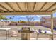 View of backyard with a barbecue and seating area under a covered patio at 2607 W Ironstone Ave, Apache Junction, AZ 85120