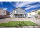 View of backyard with a gravel landscape, covered patio and gray two story house at 2607 W Ironstone Ave, Apache Junction, AZ 85120