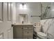 This bathroom features marble tile, a gray vanity, a toilet, and a sink at 2607 W Ironstone Ave, Apache Junction, AZ 85120