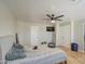 This neutral bedroom offers a ceiling fan, light, and light hardwood floors for a cozy feel at 2607 W Ironstone Ave, Apache Junction, AZ 85120