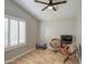 A cozy bedroom space features wood floors, shutters, and two modern brown chairs at 2607 W Ironstone Ave, Apache Junction, AZ 85120