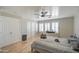 Bedroom featuring light hardwood floors, a ceiling fan, and shutters on the windows at 2607 W Ironstone Ave, Apache Junction, AZ 85120