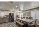 Open dining area features a large table, bench seating, and updated gray and white cabinetry at 2607 W Ironstone Ave, Apache Junction, AZ 85120