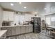 Bright kitchen features a stainless steel refrigerator, updated cabinets, and modern lighting at 2607 W Ironstone Ave, Apache Junction, AZ 85120