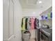Bright laundry room with modern washer and dryer, storage shelves and hanging rod at 2607 W Ironstone Ave, Apache Junction, AZ 85120