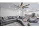 Open-concept living area showcasing a comfortable gray sectional sofa, hardwood floors, and natural light at 2607 W Ironstone Ave, Apache Junction, AZ 85120