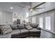 Spacious living room featuring a gray sectional sofa that flows into the modern kitchen and dining area at 2607 W Ironstone Ave, Apache Junction, AZ 85120