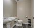 Powder room featuring a dark wood floor, elongated toilet and pedestal sink at 2607 W Ironstone Ave, Apache Junction, AZ 85120