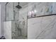 Elegant shower with white marble-patterned walls, a rainfall shower head, and a built-in bench at 2607 W Ironstone Ave, Apache Junction, AZ 85120