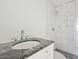 Bathroom featuring granite countertop, updated fixtures, and tile shower at 2609 N 65Th Dr, Phoenix, AZ 85035