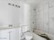 Bathroom featuring a tub with white marble tile surround and updated fixtures at 2609 N 65Th Dr, Phoenix, AZ 85035