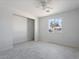 Bright bedroom featuring a ceiling fan, neutral paint and wood-look tile floors at 2609 N 65Th Dr, Phoenix, AZ 85035