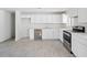 Modern kitchen with new stainless steel appliances and bright white cabinetry at 2609 N 65Th Dr, Phoenix, AZ 85035