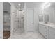 Bright bathroom showcasing a walk-in shower with white marble tile and double vanity at 280 W Wisteria Pl, Chandler, AZ 85248