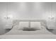 Elegant bedroom with tufted headboard, stylish bedside chandeliers and floating nightstands at 280 W Wisteria Pl, Chandler, AZ 85248