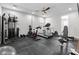Well-equipped home gym with a variety of exercise machines and rubber flooring at 280 W Wisteria Pl, Chandler, AZ 85248