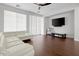 Comfortable living room with hardwood floors, a TV, and ample seating at 280 W Wisteria Pl, Chandler, AZ 85248