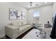Home office area with sofa, modern desk, chair, and light gray decor at 280 W Wisteria Pl, Chandler, AZ 85248