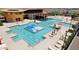 Aerial view of the community pool with multiple lounge chairs and splash pad at 30386 N Juniper Dr, Florence, AZ 85132