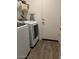 Well-equipped laundry room with washer, dryer, and ample shelving for storage at 30386 N Juniper Dr, Florence, AZ 85132